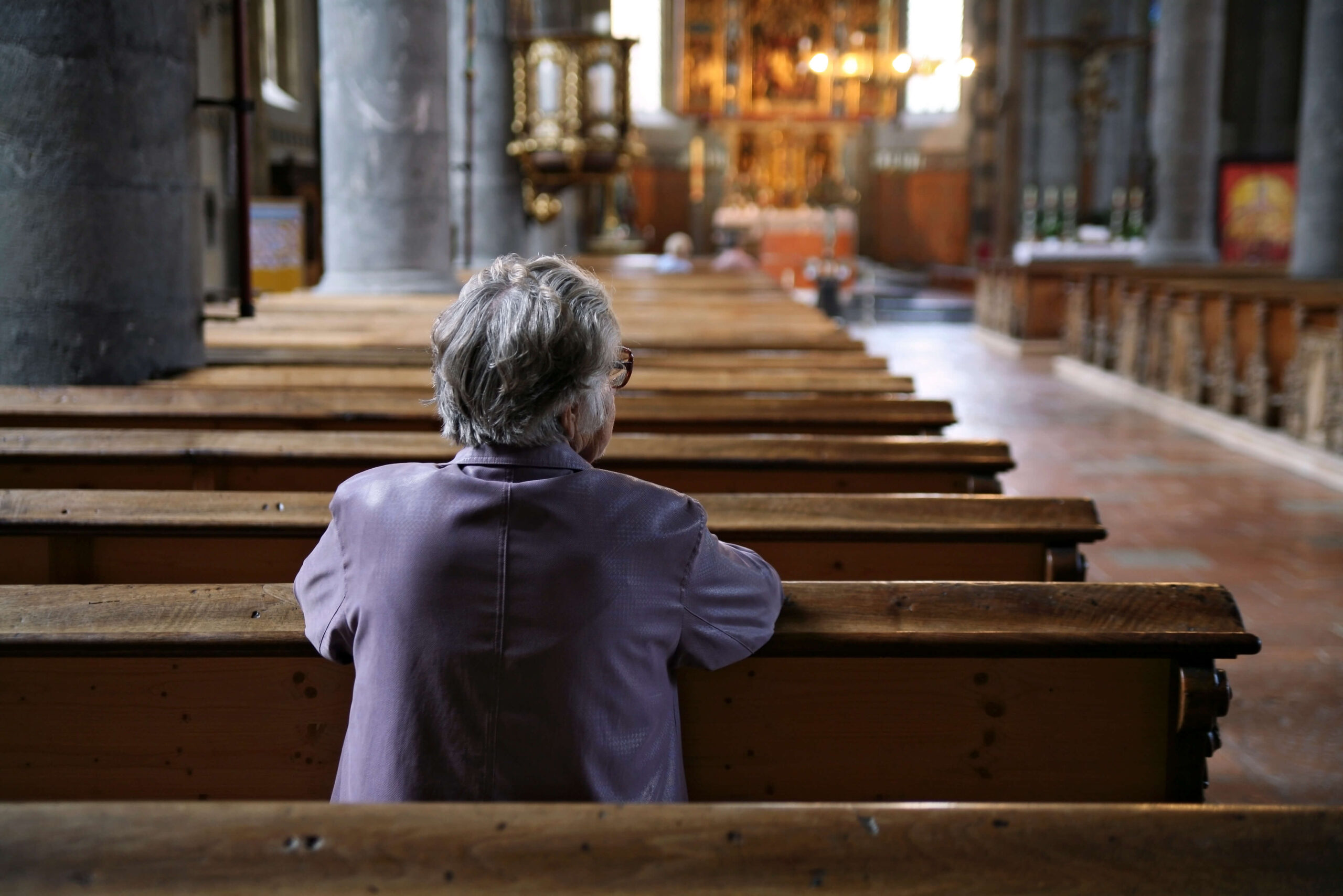 Woman prays in a church