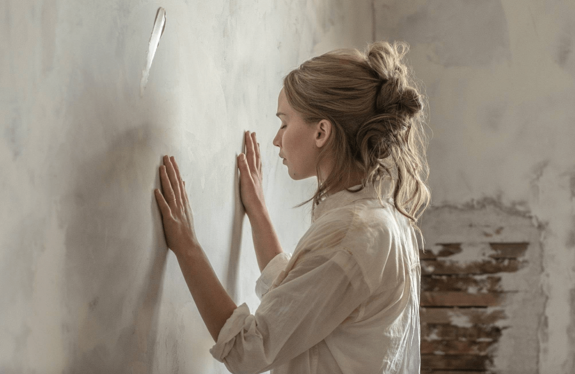 Jennifer Jennifer Lawrence as the title character in Mother! touching the wall with both hands and closing her eyes (IMDb)
