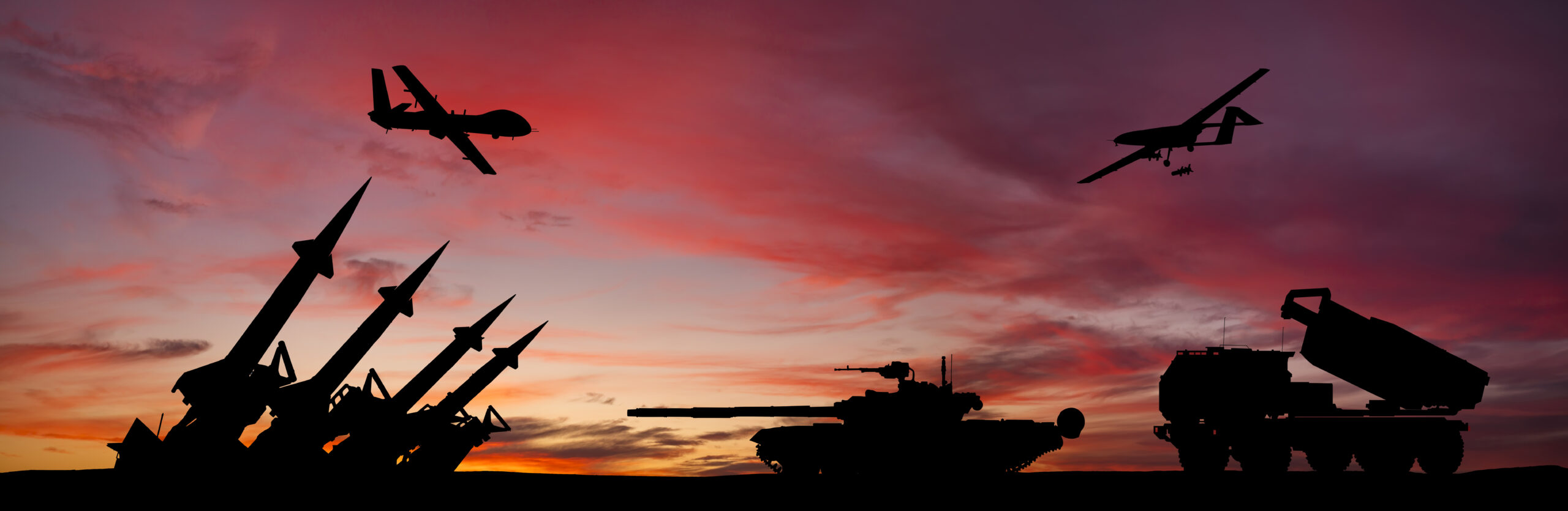 Weapons and airplanes in front of sunset (Anton Petrus/Getty Images)