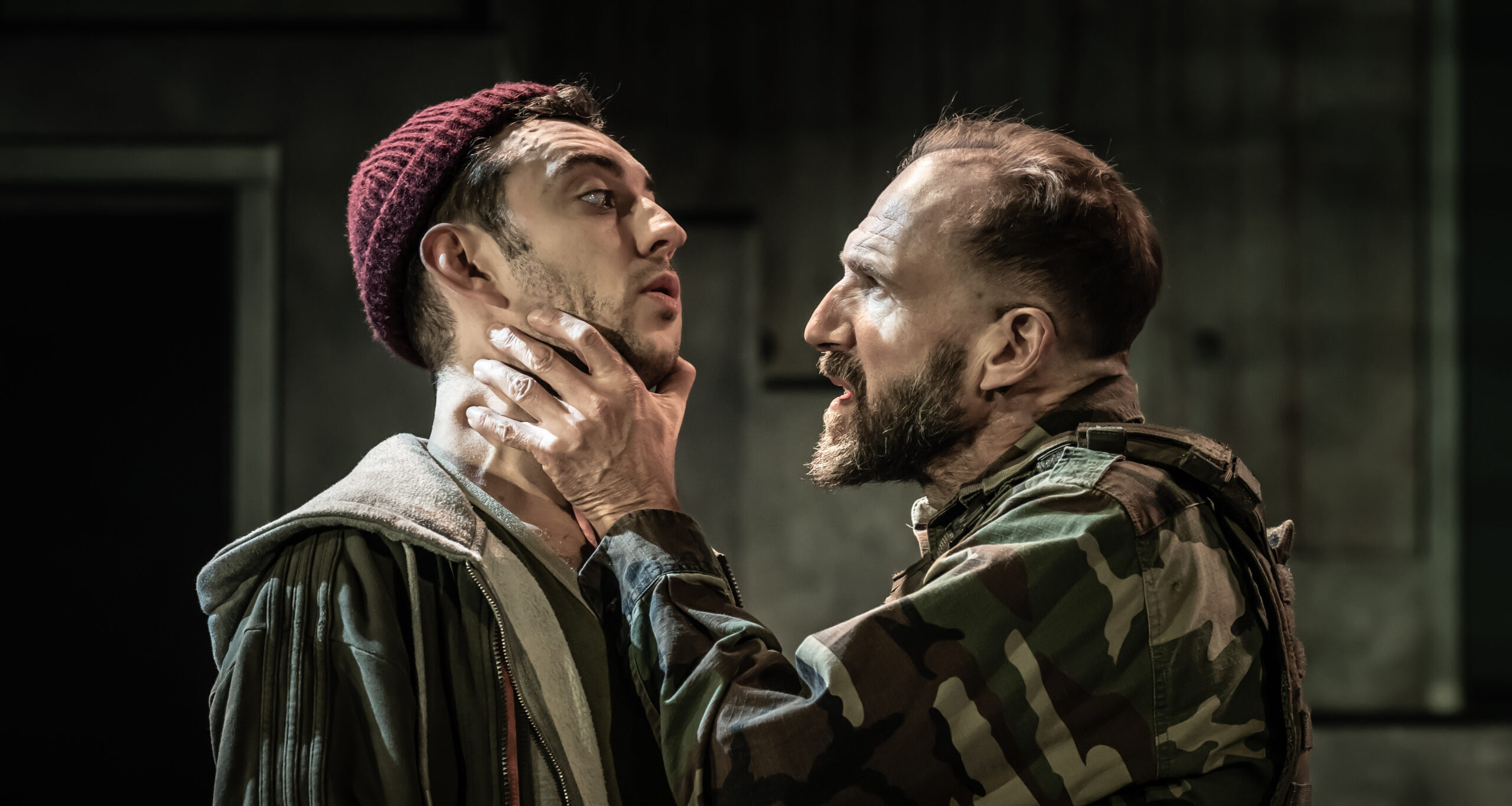 First Murderer played by Jake Neads being choked by Macbeth played by Ralph Fiennes (Marc Brenner)
