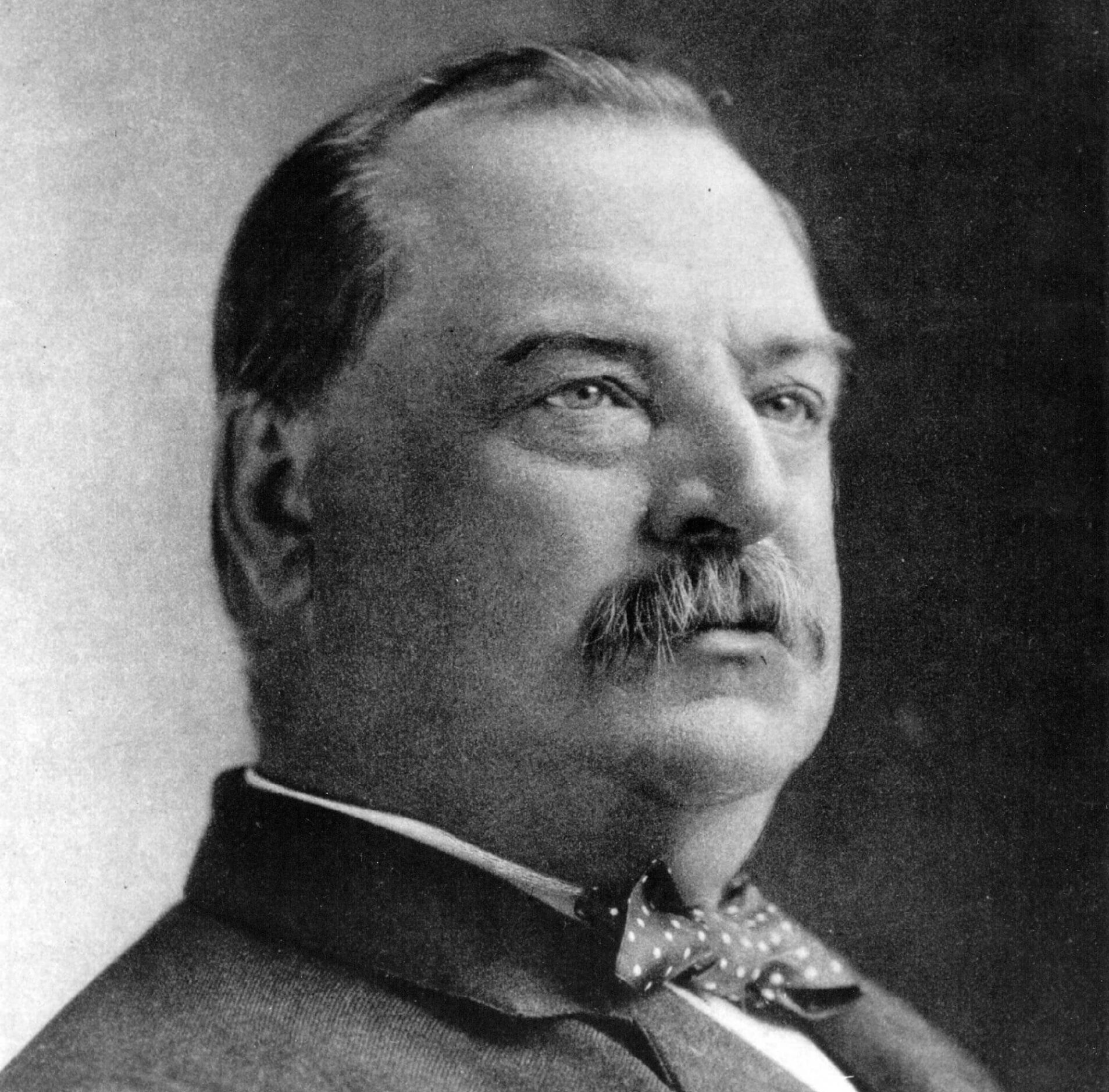 Black and white photo of Grover Cleveland in a suit