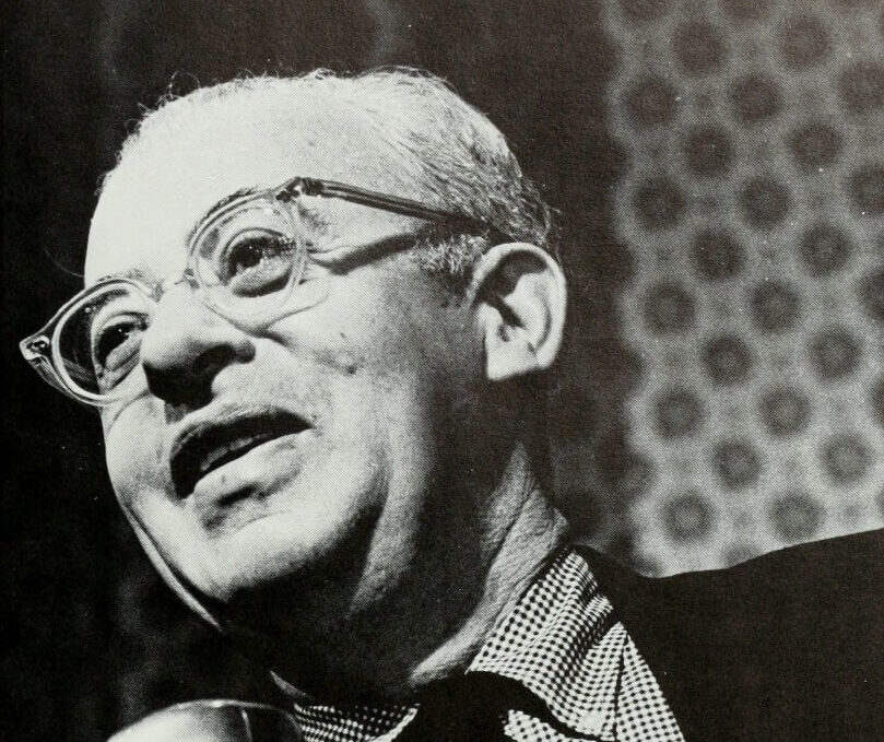 Black and white photo of a man in glasses